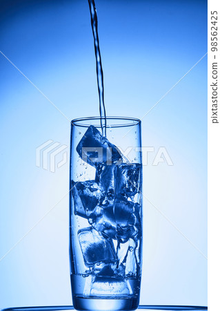 water drops falling into deep blue water water drops falling into deep blue water 98562425