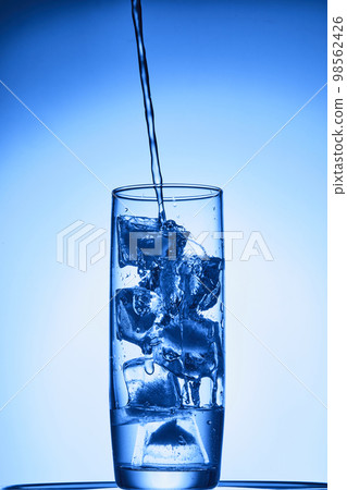 water drops falling into deep blue water water drops falling into deep blue water 98562426