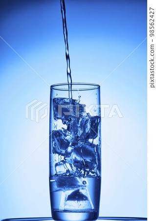 water drops falling into deep blue water water drops falling into deep blue water 98562427