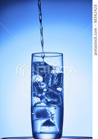 water drops falling into deep blue water water drops falling into deep blue water 98562428