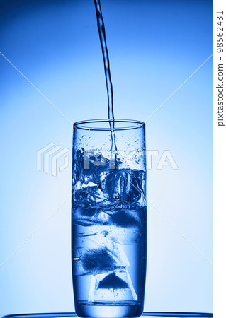water drops falling into deep blue water water drops falling into deep blue water 98562431