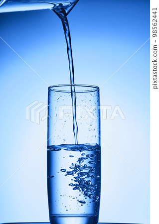 water drops falling into deep blue water water drops falling into deep blue water 98562441
