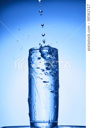 water drops falling into deep blue water water drops falling into deep blue water 98562517