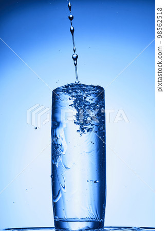 water drops falling into deep blue water 98562518