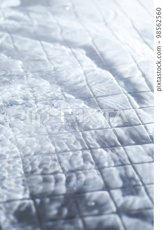 water drops falling into deep blue water 98562560