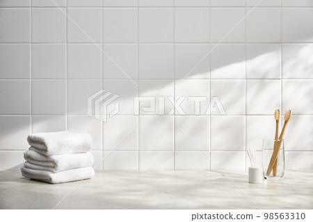 Various bathroom accessories on a tiled background Various bathroom accessories on a tiled background 98563310