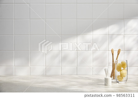 Various bathroom accessories on a tiled background Various bathroom accessories on a tiled background 98563311