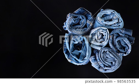 Twisted jeans on a dark background Twisted jeans on a dark background 98563535