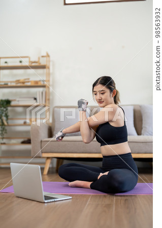 sport, fitness and healthy lifestyle concept - Portrait happy smiling young asian woman with laptop computer stretching arm at home sport, fitness and healthy lifestyle concept - Portrait happy smiling young asian woman with laptop computer stretching arm at home 98563932