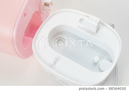 disassembled pink humidifier on a white background. device for home disassembled pink humidifier on a white background. device for home 98564030
