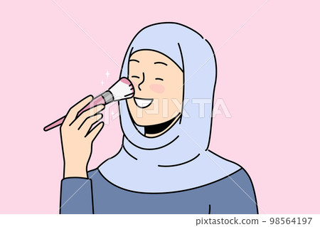 Smiling woman in hijab doing makeup  98564197