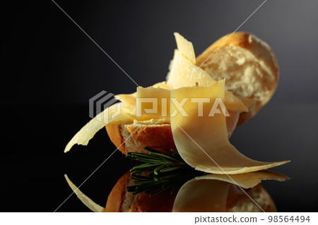 Sandwich with Parmesan cheese and rosemary. 98564494
