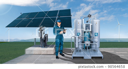 Engineer with tablet computer controls green hydrogen factory. Engineer with tablet computer controls green hydrogen factory. 98564658