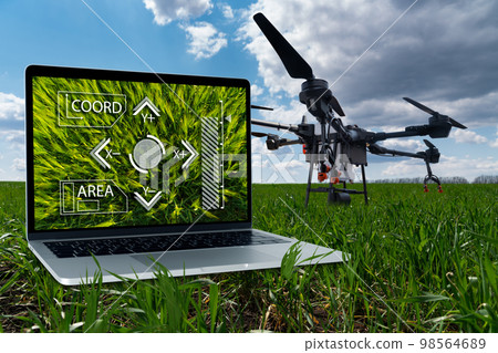 Drone sprayer and laptop. Drone sprayer and laptop. 98564689