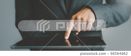 Businessman using a tablet in hands underneath the search tab. Business, technology, internet and networking concept.. Businessman using a tablet in hands underneath the search tab. Business, technology, internet and networking concept.. 98564862