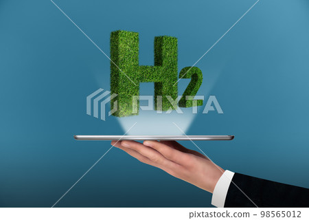 A man is holding a digital tablet with symbol of Hydrogen H2 A man is holding a digital tablet with symbol of Hydrogen H2 98565012