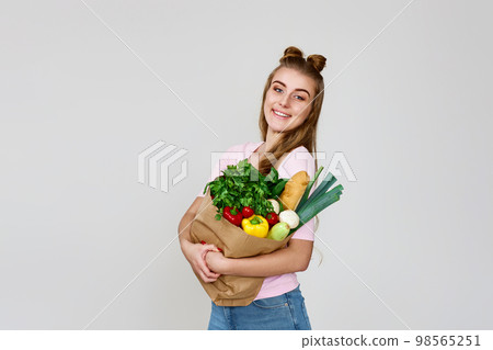 vegetarian woman hold paper bag with vegetables 98565251