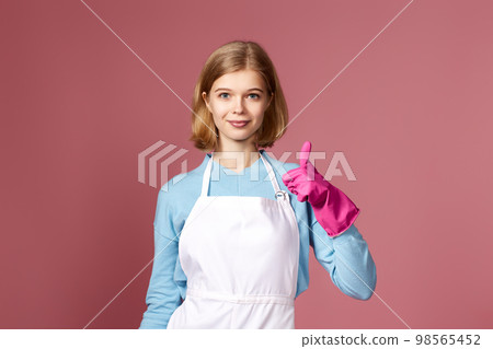 woman in rubber gloves and cleaner apron showing ok sign 98565452