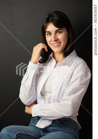 young woman in a white shirt and jeans 98565697