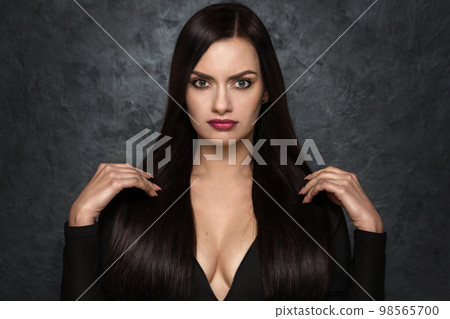 Luxurious woman with black chic hair with a deep neckline 98565700