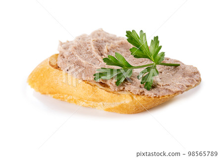 Meat pate on baguette with parsley, close-up Meat pate on baguette with parsley, close-up 98565789
