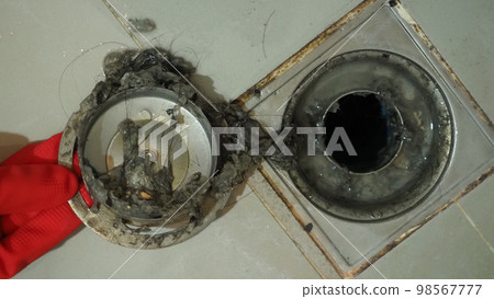 Drain cleaning. Clogged and dirty sewer pipes floor drain. Full of hair and accumulated clogged grease. Maintenance the floor drain sewage system in bathroom. fixing clean wash and unclog a drain. Drain cleaning. Clogged and dirty sewer pipes floor drain. Full of hair and accumulated clogged grease. Maintenance the floor drain sewage system in bathroom. fixing clean wash and unclog a drain. 98567777