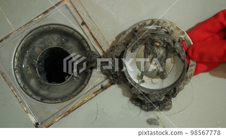 Drain cleaning. Clogged and dirty sewer pipes floor drain. Full of hair and accumulated clogged grease. Maintenance the floor drain sewage system in bathroom. fixing clean wash and unclog a drain. Drain cleaning. Clogged and dirty sewer pipes floor drain. Full of hair and accumulated clogged grease. Maintenance the floor drain sewage system in bathroom. fixing clean wash and unclog a drain. 98567778