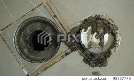 Drain cleaning. Clogged and dirty sewer pipes floor drain. Full of hair and accumulated clogged grease. Maintenance the floor drain sewage system in bathroom. fixing clean wash and unclog a drain. Drain cleaning. Clogged and dirty sewer pipes floor drain. Full of hair and accumulated clogged grease. Maintenance the floor drain sewage system in bathroom. fixing clean wash and unclog a drain. 98567779