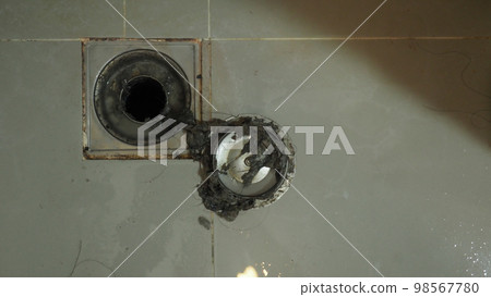 Drain cleaning. Clogged and dirty sewer pipes floor drain. Full of hair and accumulated clogged grease. Maintenance the floor drain sewage system in bathroom. fixing clean wash and unclog a drain. 98567780