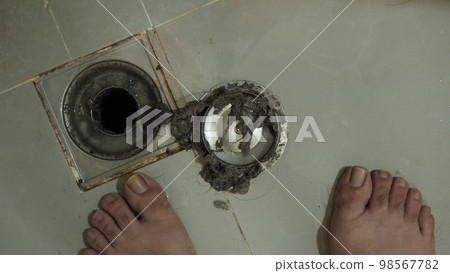 Drain cleaning. Clogged and dirty sewer pipes floor drain. Full of hair and accumulated clogged grease. Maintenance the floor drain sewage system in bathroom. fixing clean wash and unclog a drain. Drain cleaning. Clogged and dirty sewer pipes floor drain. Full of hair and accumulated clogged grease. Maintenance the floor drain sewage system in bathroom. fixing clean wash and unclog a drain. 98567782