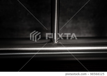 stainless steel railings on a dark background stainless steel railings on a dark background 98568125