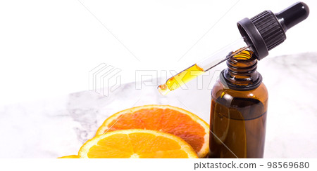 Vitamin C serum bottle with dropper on white marble background 98569680