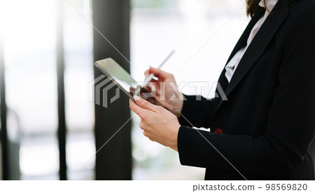 businesswoman hand using smart phone, tablet payments and holding credit card online shopping, omni channel, digital tablet docking keyboard computer at office businesswoman hand using smart phone, tablet payments and holding credit card online shopping, omni channel, digital tablet docking keyboard computer at office 98569820