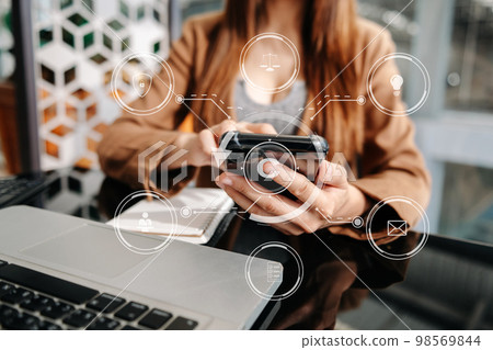 Copyright or patent concept, Person hand using laptop computer, tablet and smartphone with virtual screen copyright icon trademark, Creation ownership against piracy. .. 98569844