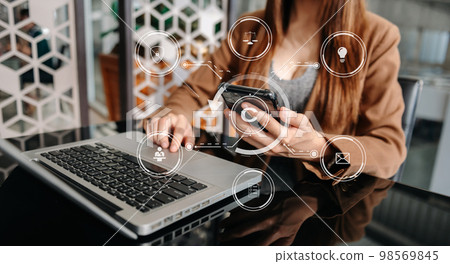 Copyright or patent concept, Person hand using laptop computer, tablet and smartphone with virtual screen copyright icon trademark, Creation ownership against piracy. at office 98569845