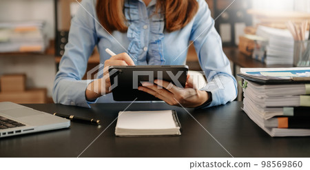 Businesswoman working with VR wide blank screen tablet, computer and smart phone on office blur background. Businesswoman working with VR wide blank screen tablet, computer and smart phone on office blur background. 98569860