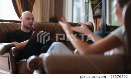 Psychotherapist listens to story of woman patient and makes notes in notebook. Psychotherapist listens to story of woman patient and makes notes in notebook. 98570792