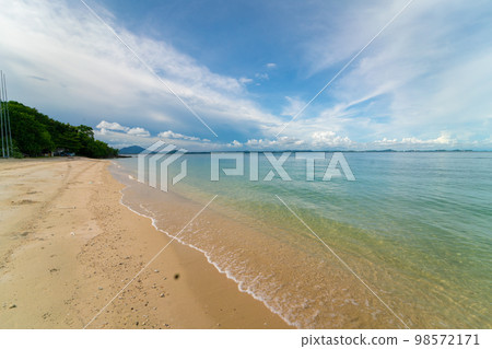 Sea beach wave splash on white sand beach against blue sky cloud Sea beach wave splash on white sand beach against blue sky cloud 98572171