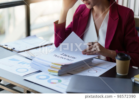 Asian Business woman working at home office and analyze financial report document. Accounting and Finance concept 98572390