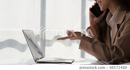 Asian Business woman working at home office and analyze financial report document. Accounting and Finance concept Asian Business woman working at home office and analyze financial report document. Accounting and Finance concept 98572489