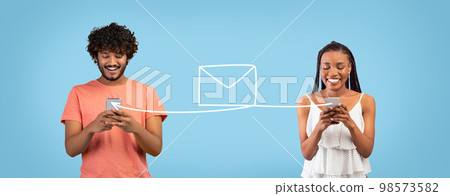 Dating App. Arab Man And Black Woman Messaging Online Via Smartphone Dating App. Arab Man And Black Woman Messaging Online Via Smartphone 98573582