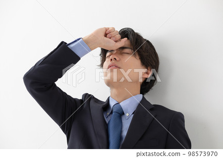 Businessman headache fever worry Businessman headache fever worry 98573970