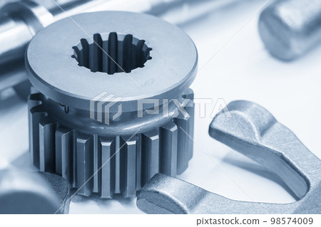 Close-up scene of transmission gear spare parts in the light blue scene. Close-up scene of transmission gear spare parts in the light blue scene. 98574009