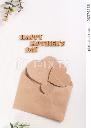 Happy mother's day. Wooden letters, cardboard hearts in an envelope and eucalyptus branches. Happy mother's day. Wooden letters, cardboard hearts in an envelope and eucalyptus branches. 98574288