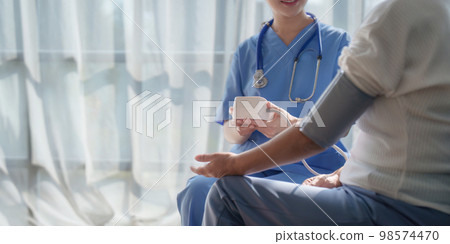 Home healthcare nurse, physical therapy with senior adult woman at home Home healthcare nurse, physical therapy with senior adult woman at home 98574470