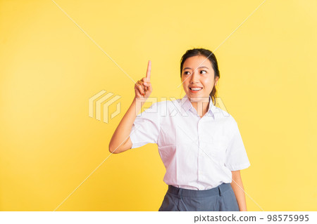 teenage asian girl in uniform with one finger pointing gesture 98575995