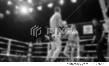 Blurred images black and white photo style of Thai boxing or Muay Thai or Kickboxing which local and foriegn boxer are fighting on the ring at indoor stage as martial art sport. Muay Thai Kick boxing Blurred images black and white photo style of Thai boxing or Muay Thai or Kickboxing which local and foriegn boxer are fighting on the ring at indoor stage as martial art sport. Muay Thai Kick boxing 98576456