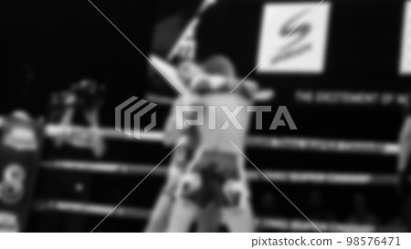Blurred images black and white photo style of Thai boxing or Muay Thai or Kickboxing which local and foriegn boxer are fighting on the ring at indoor stage as martial art sport. Muay Thai Kick boxing Blurred images black and white photo style of Thai boxing or Muay Thai or Kickboxing which local and foriegn boxer are fighting on the ring at indoor stage as martial art sport. Muay Thai Kick boxing 98576471