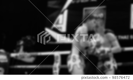 Blurred images black and white photo style of Thai boxing or Muay Thai or Kickboxing which local and foriegn boxer are fighting on the ring at indoor stage as martial art sport. Muay Thai Kick boxing Blurred images black and white photo style of Thai boxing or Muay Thai or Kickboxing which local and foriegn boxer are fighting on the ring at indoor stage as martial art sport. Muay Thai Kick boxing 98576472