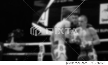 Blurred images black and white photo style of Thai boxing or Muay Thai or Kickboxing which local and foriegn boxer are fighting on the ring at indoor stage as martial art sport. Muay Thai Kick boxing Blurred images black and white photo style of Thai boxing or Muay Thai or Kickboxing which local and foriegn boxer are fighting on the ring at indoor stage as martial art sport. Muay Thai Kick boxing 98576475